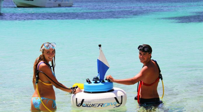 Two people standing next to a Power Dive bouy