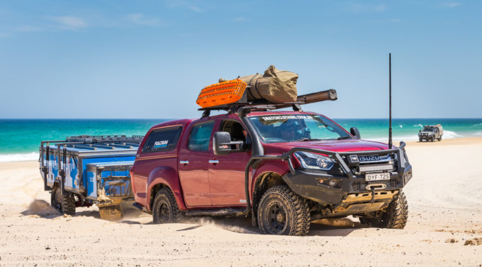 A 4WD and trailer driving over the beach