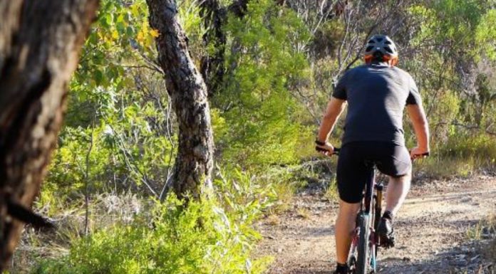 A man cycling in the outback of Esperance