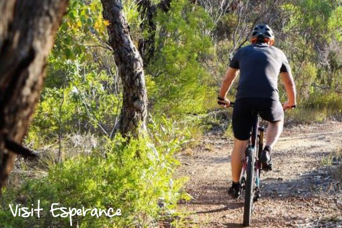A man cycling in the outback of Esperance